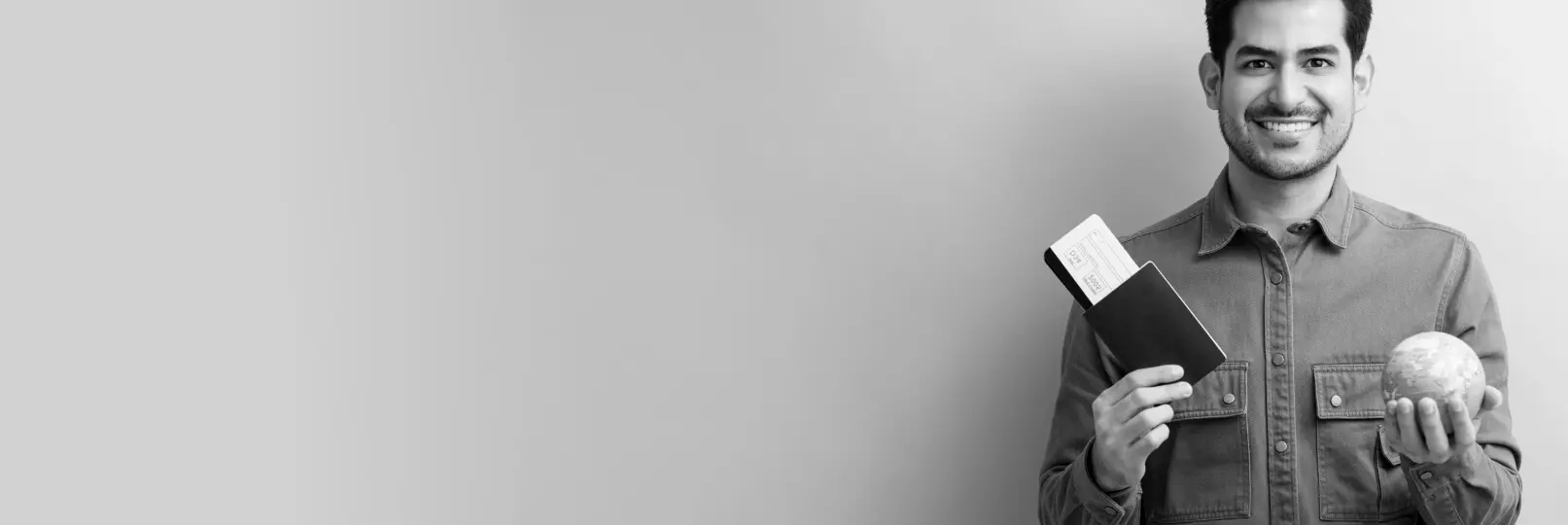 A man holding a ticket and a globe